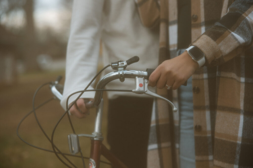 Close up of girlfriend and boyfriend hands on the bike