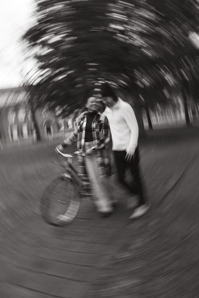 blurry photo of the couple walking with the bike