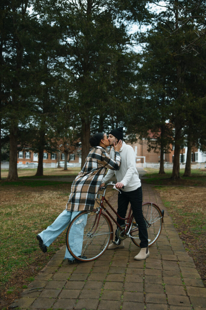 couple kissing in the middle of the sidewalk